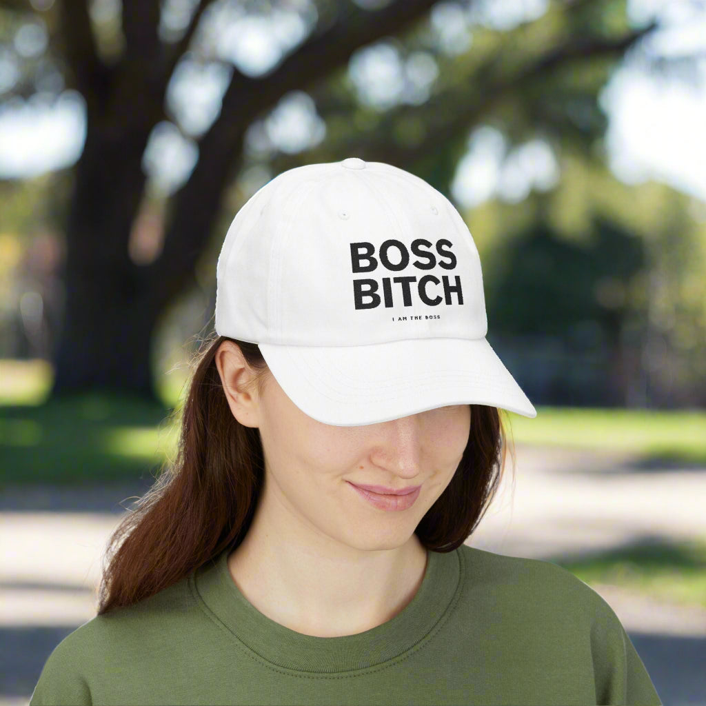 Person wearing a white cap with 'BOSS BITCH' text on a white background
